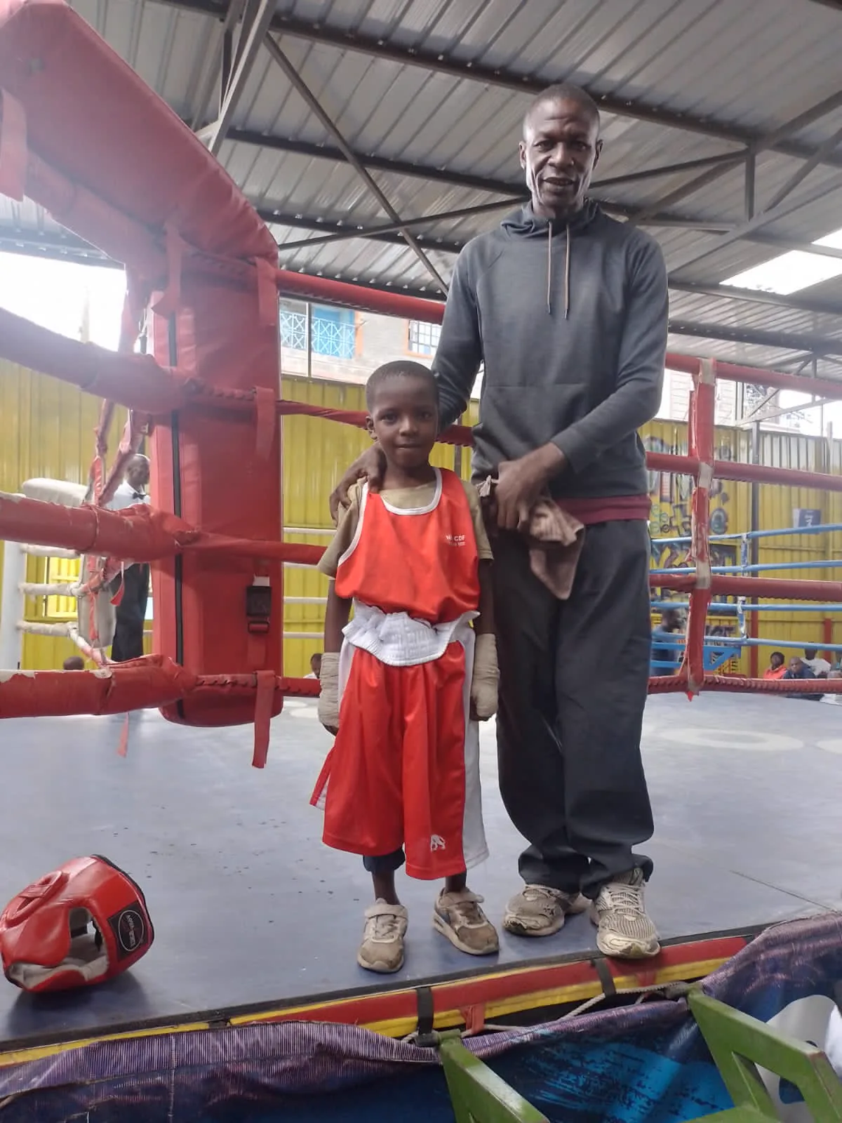 Coach Ogeya with a young boxer
